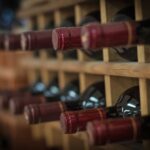 red wine bottle stacked on wooden racks