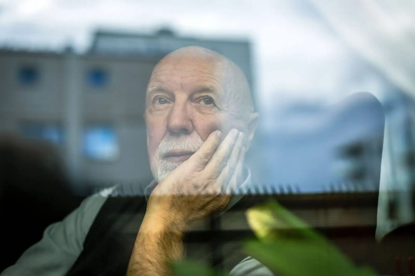 CLARE-Loneliness-Blog-Featured-Image Lonely senior man staring out a window