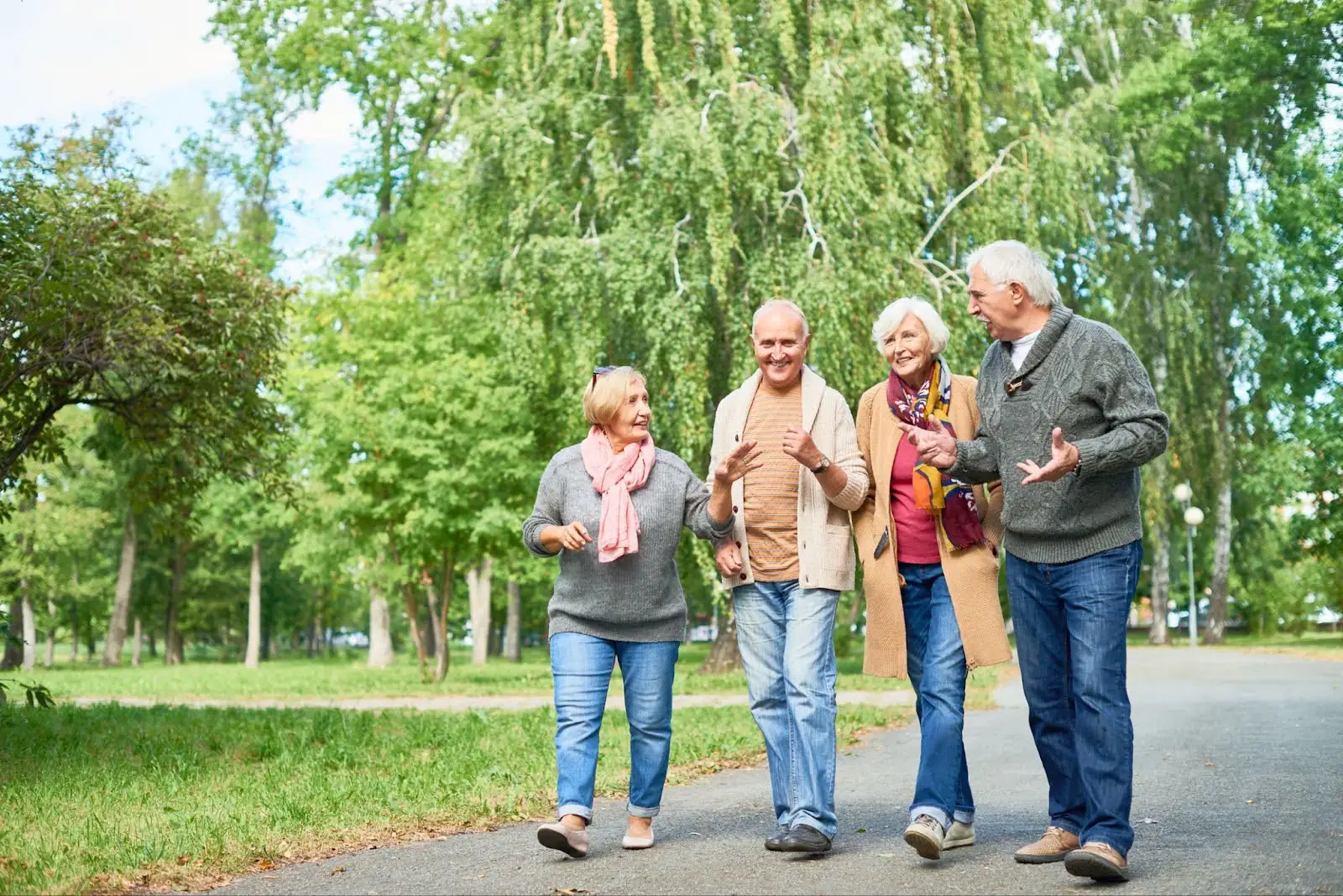 Group of seniors walking together outside and looking happy