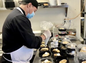 Cook Arturo Huizer adds finishing touches to desserts ahead of dinner service at The Clare.