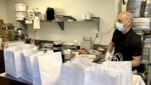 Director of Dining Services Francesco Tardio organizes lunch orders for delivery to residents.