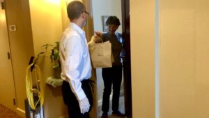 Server Sandy Neal delivers lunch to Clare resident Joanne Celewycz.