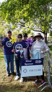 Group of people holding Silver Sponsor sign