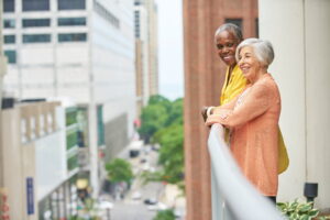 man and lady on balcony overlooking the city