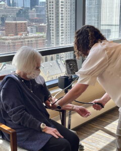 A nurse taking a ladies blood pressure