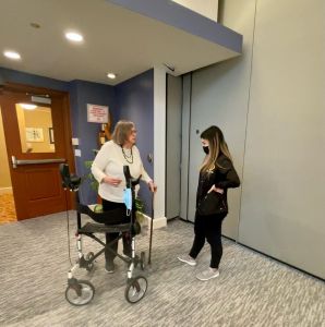 two ladies in hall one with a walker