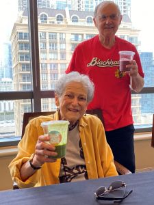 Couple at table holding drinks