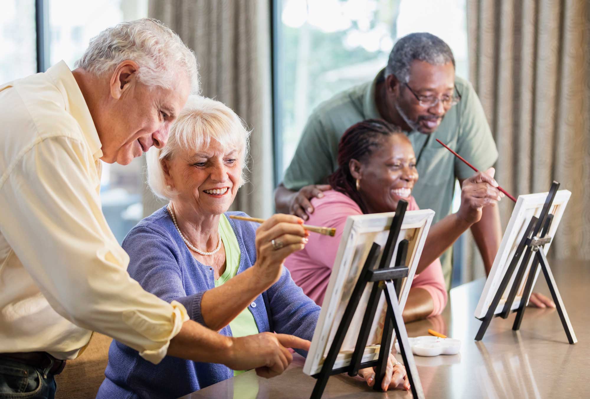 A group of seniors participating in a painting class