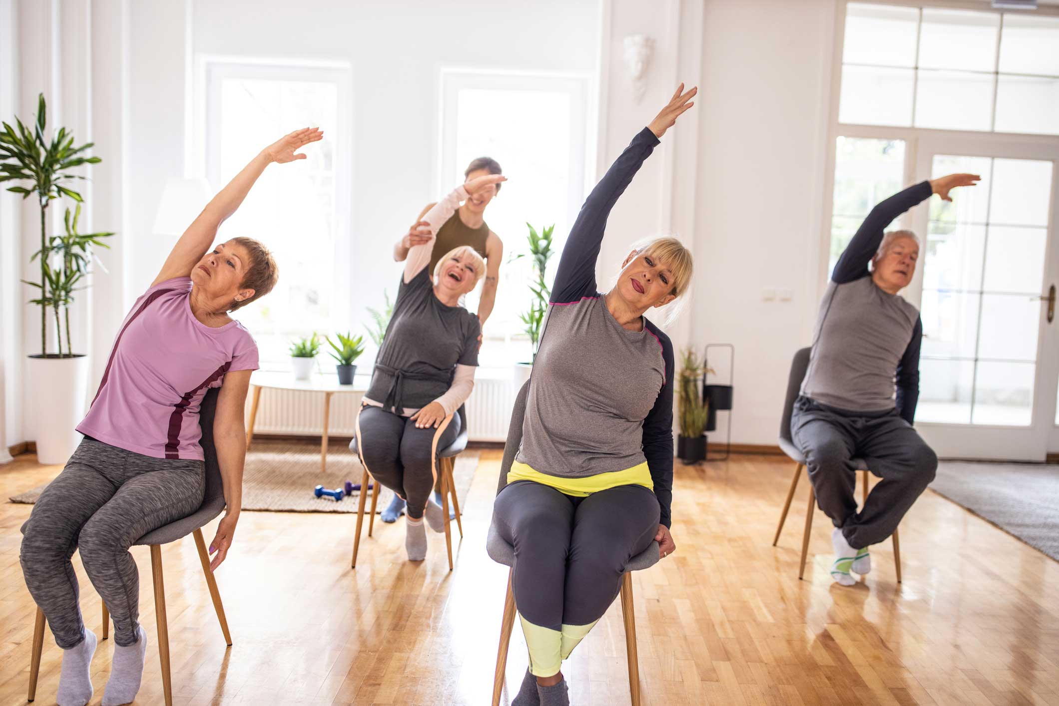 iStock-1314539036-(2) seniors participating in a Chair Pilates class