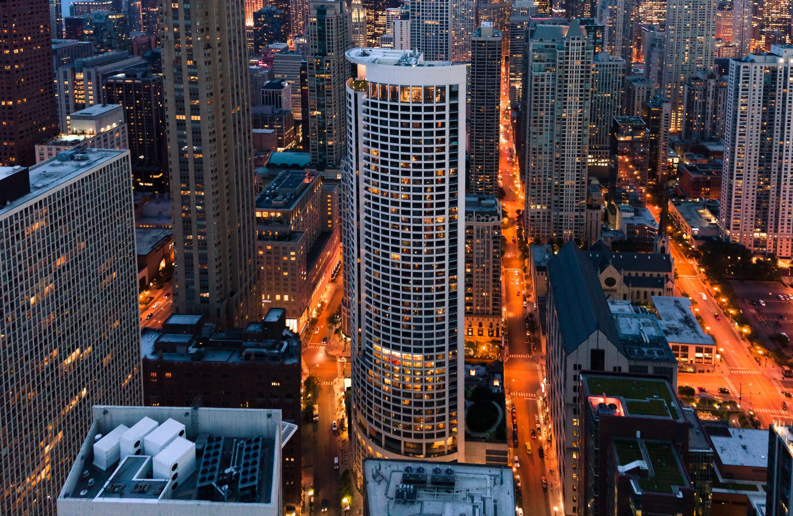 An aerial view of The Clare building at night in Chicago, IL.