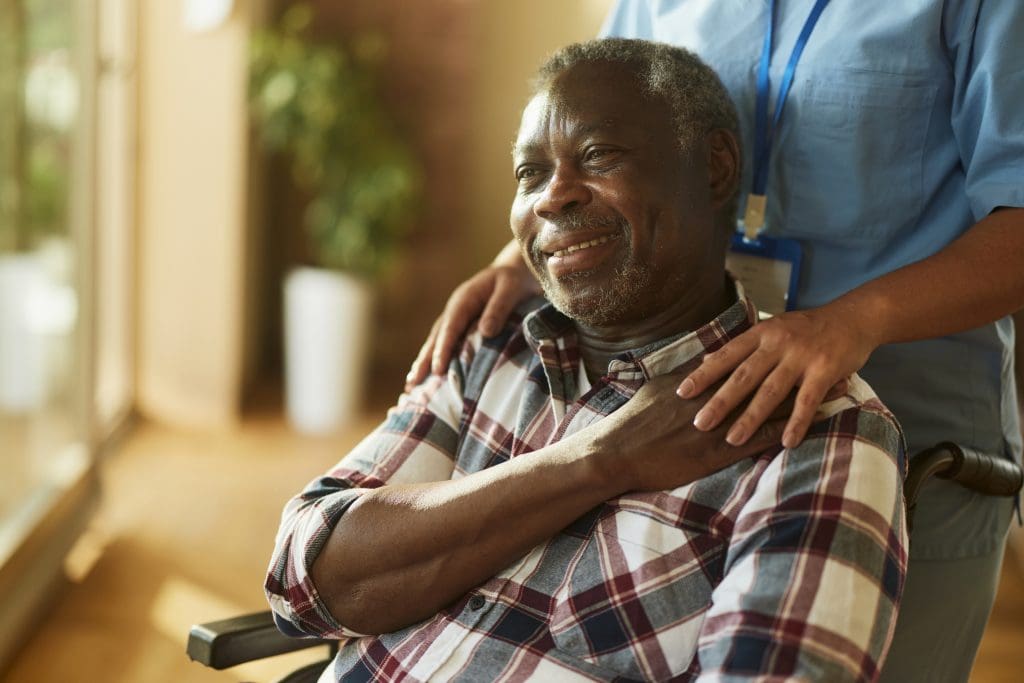 Portrait of senior man in wheelchair with peace of mind.