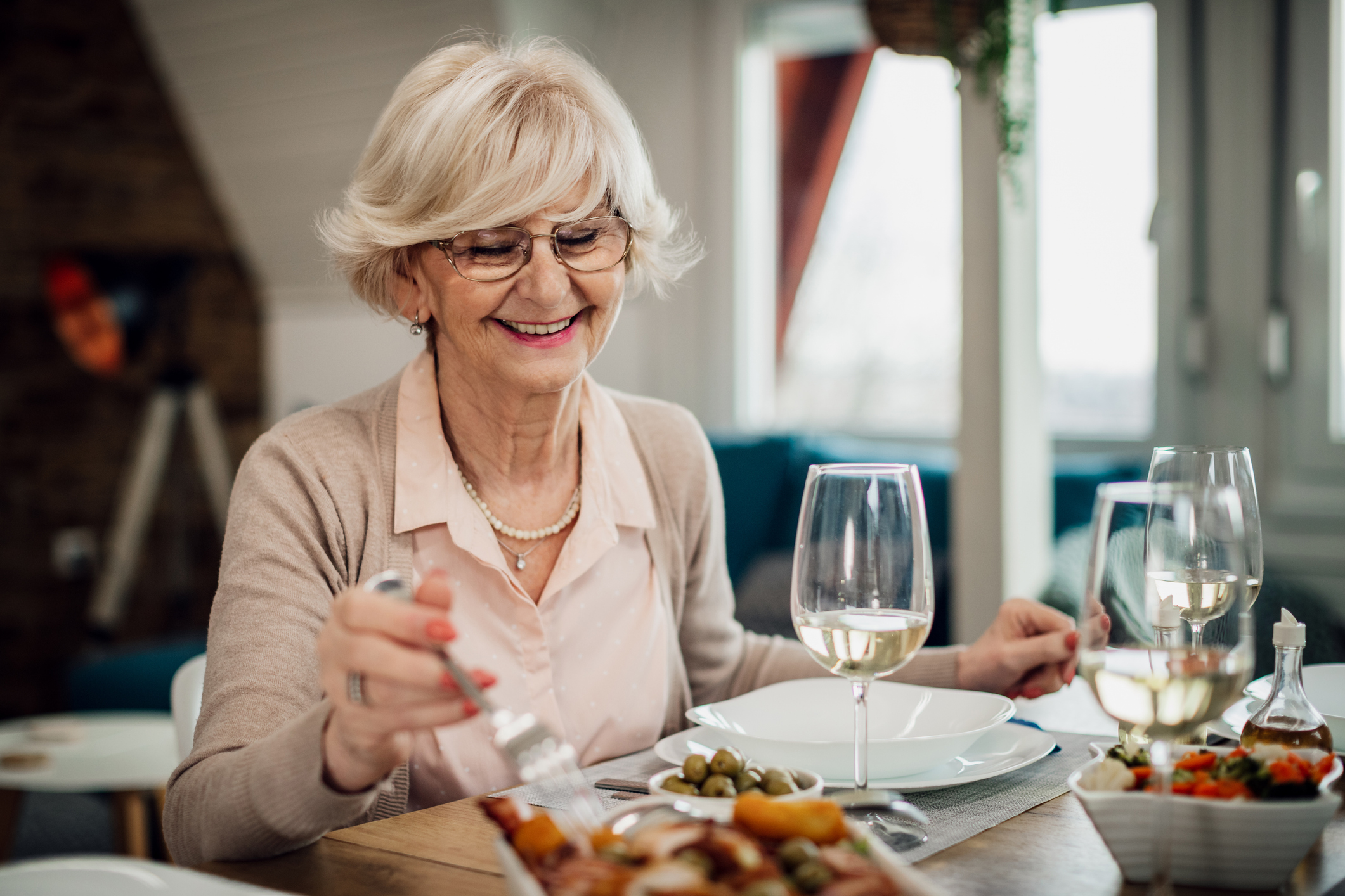 senior woman smiling and eating lunch